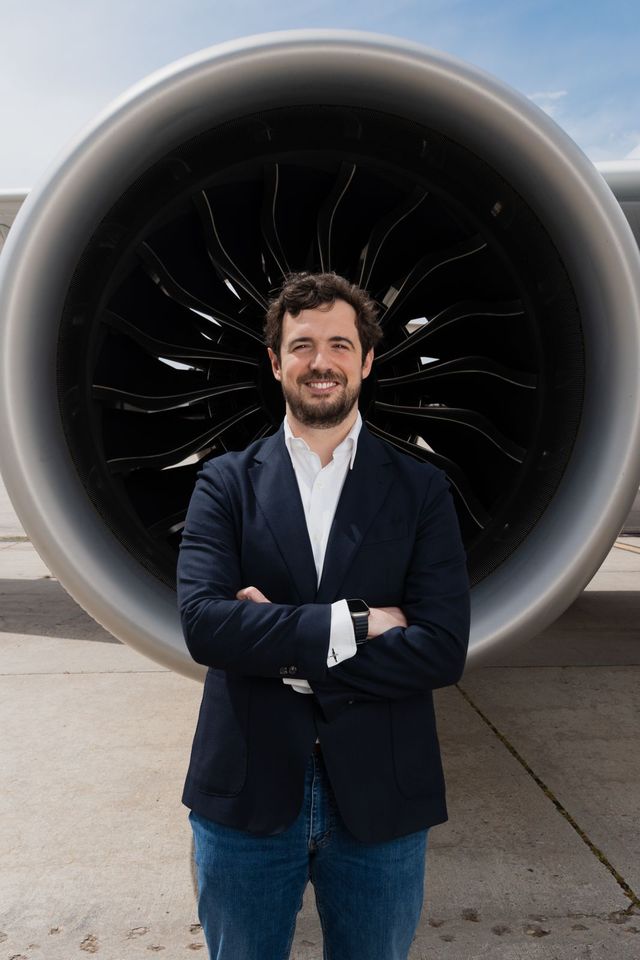 Martín Beitia in front of an aircraft engine